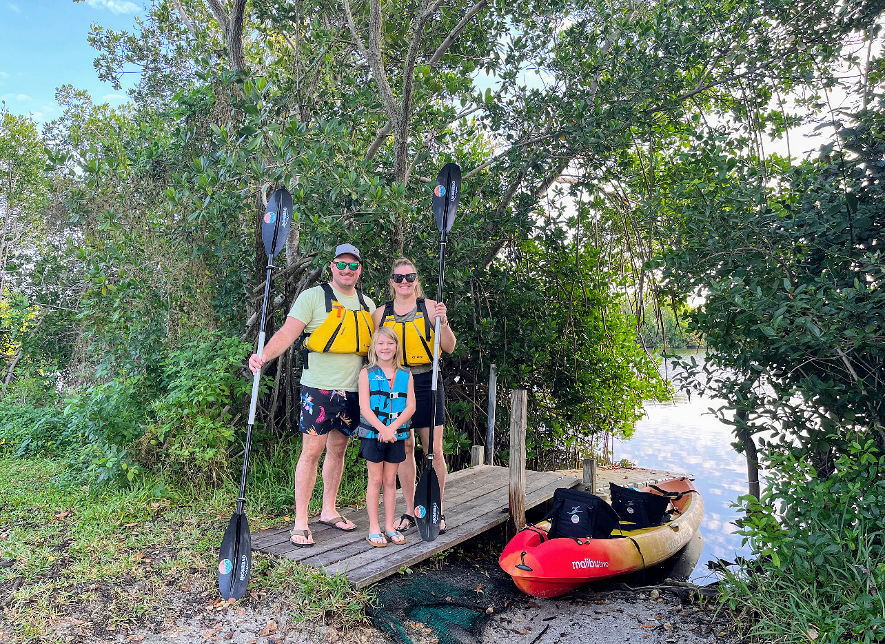 a group of people standing next to a tree