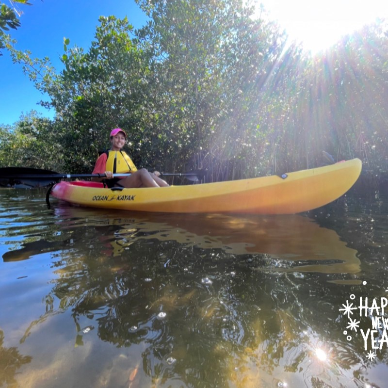a man riding on the back of a boat in the water