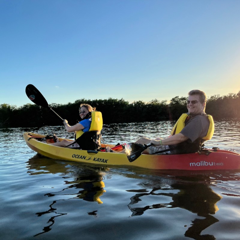 a man riding on the back of a boat in the water