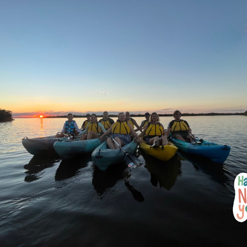 a group of people in a boat on a body of water
