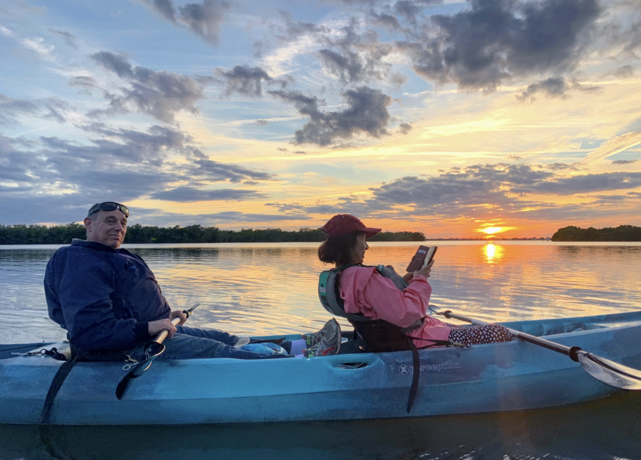 a couple of people on a boat in a body of water