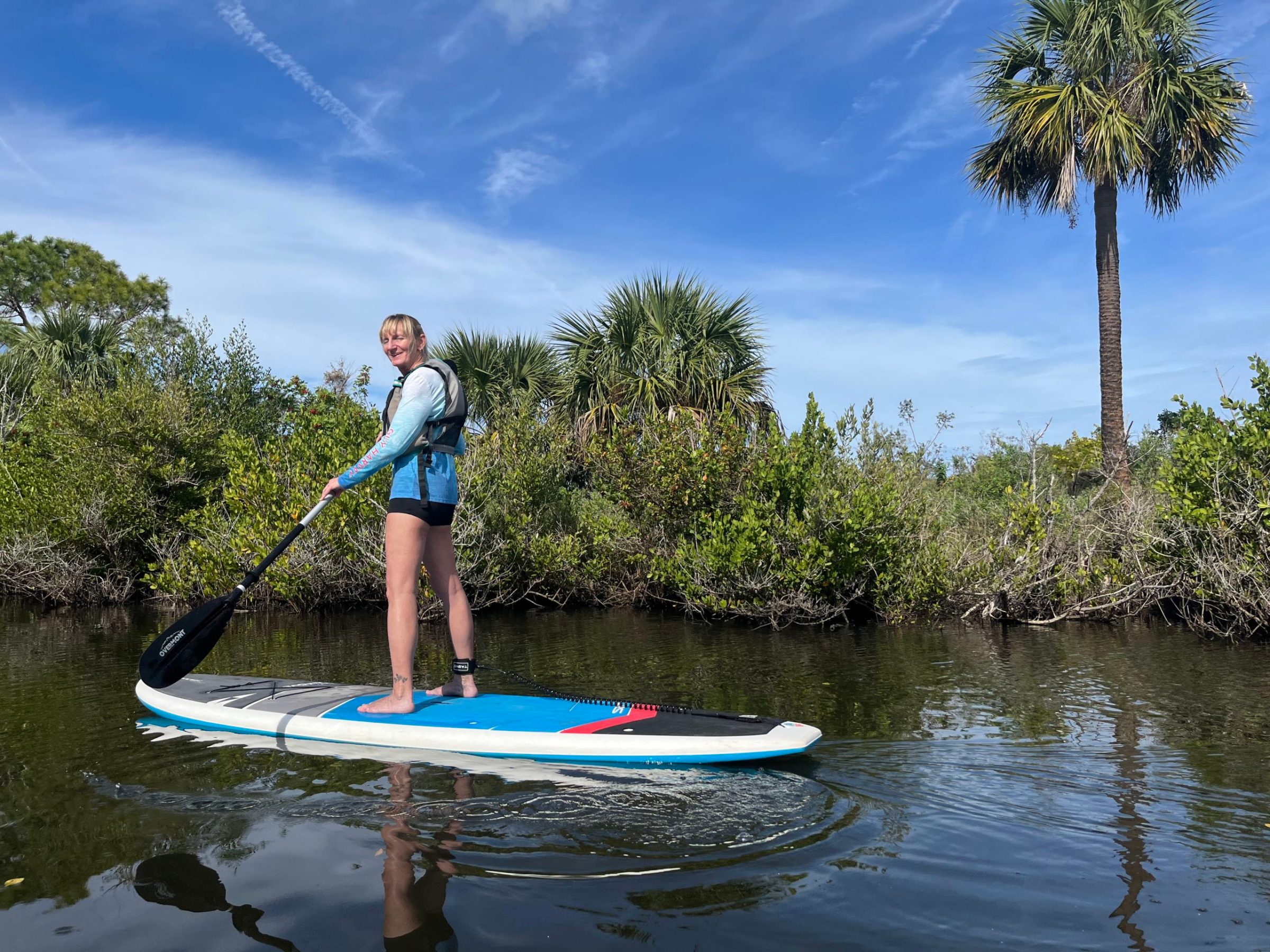 a young boy riding a skate board in the water