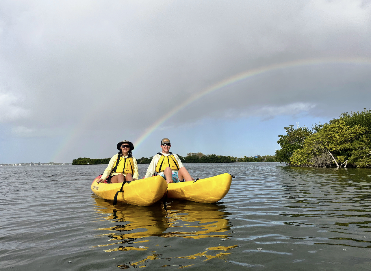 a man riding on the back of a boat in the water