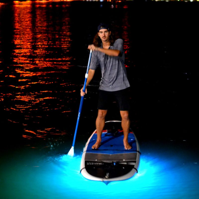 a man standing next to a body of water