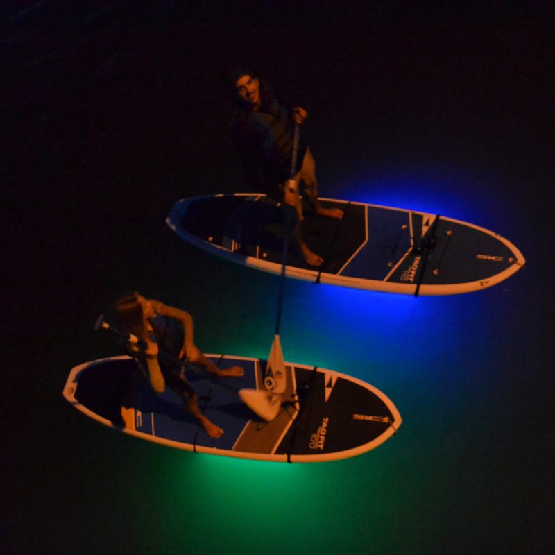 a man on a surf board in the dark
