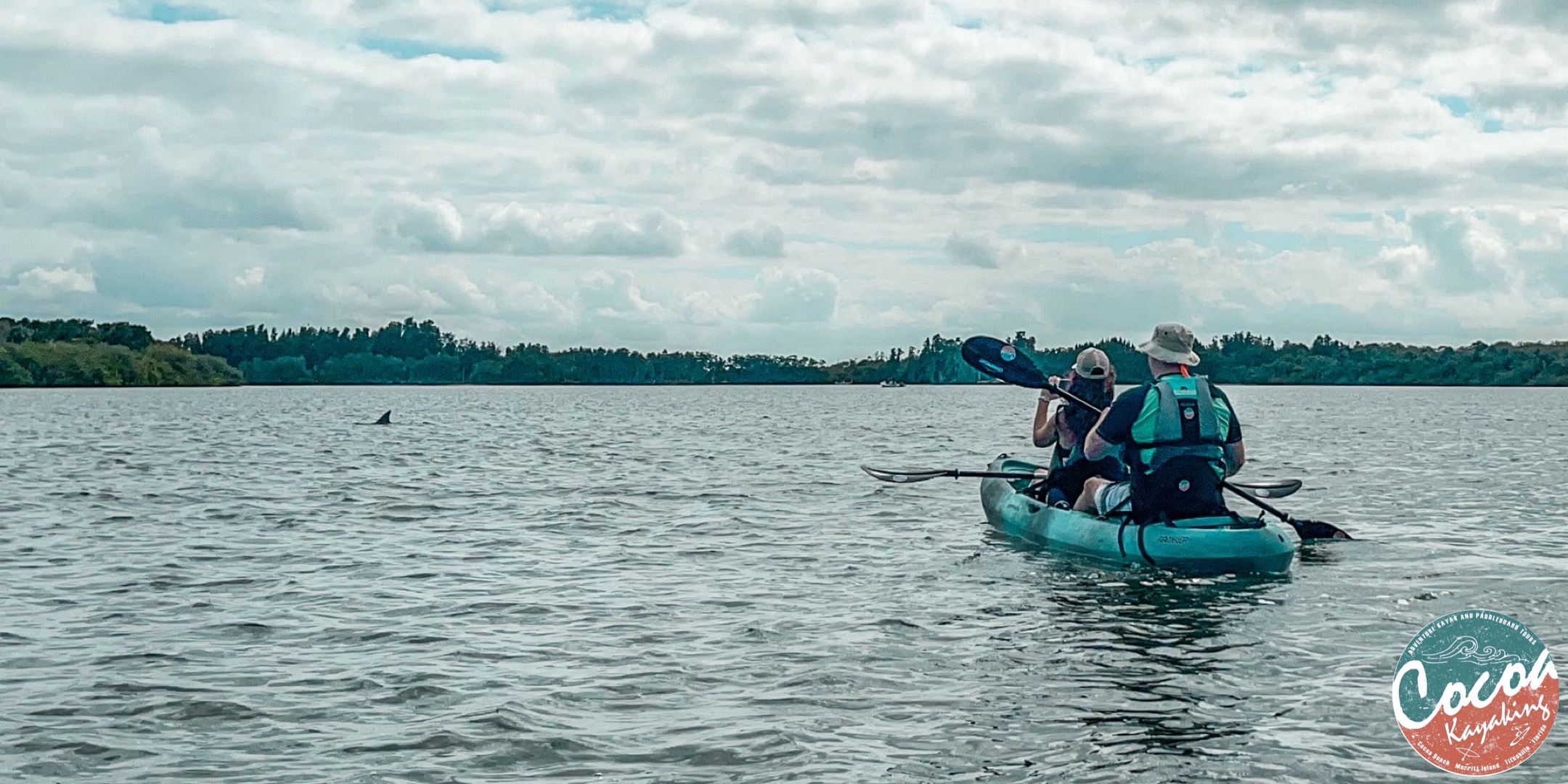 EEE7EFD5-938F-4E9A-906F-9B08FE161622 a person riding on the back of a boat in a body of water