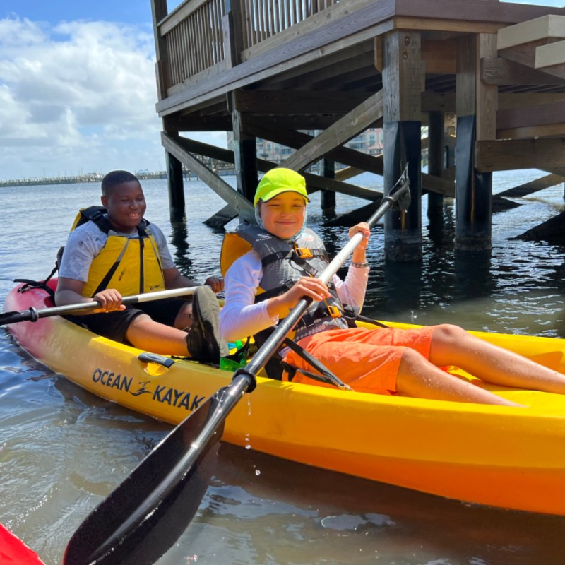 a group of people in a boat on a body of water