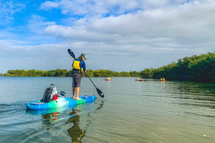 a person riding on the back of a boat in the water
