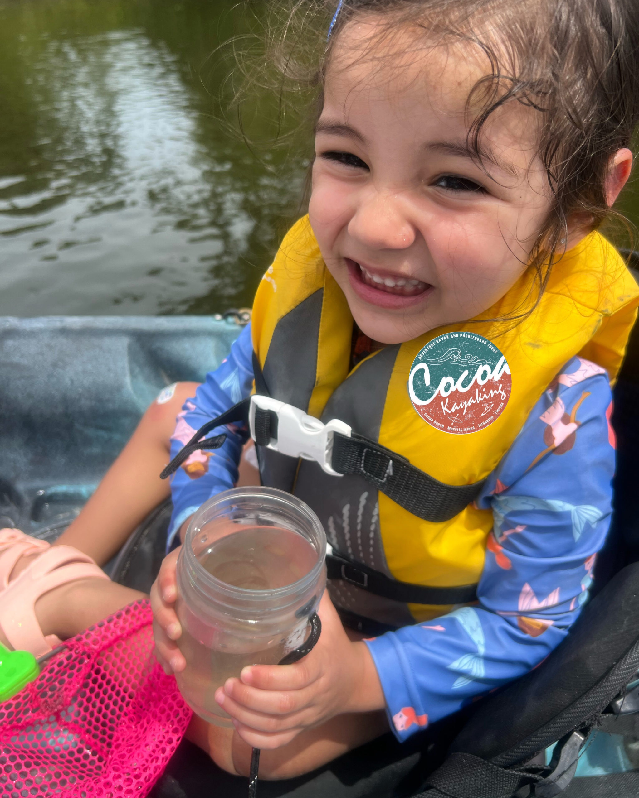 a boy drinking water from a lake