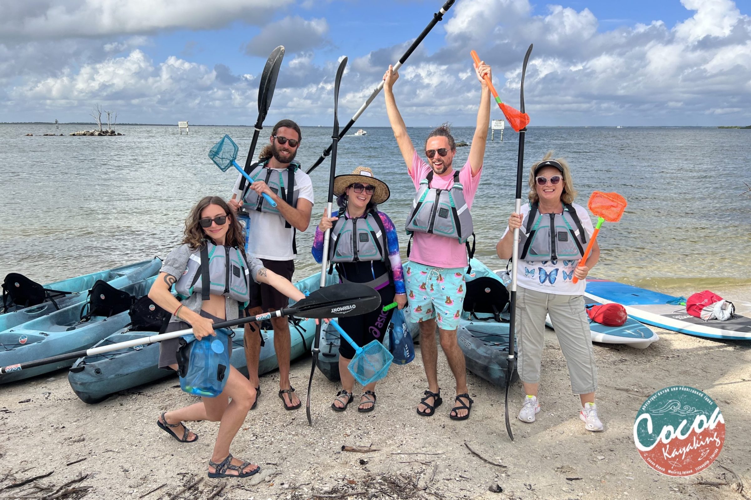 a group of people sitting at a beach