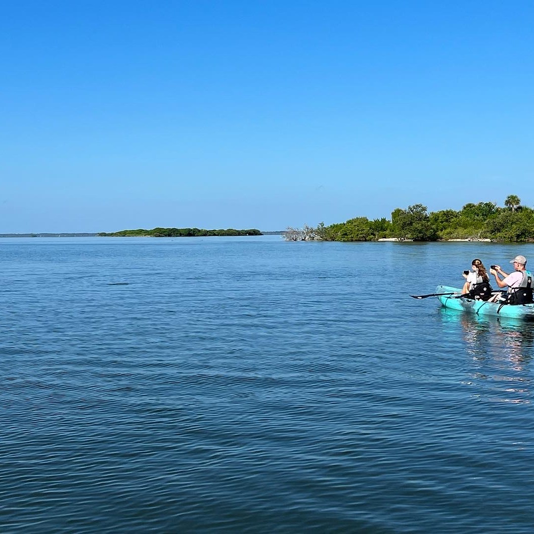 a group of people in a boat on a body of water