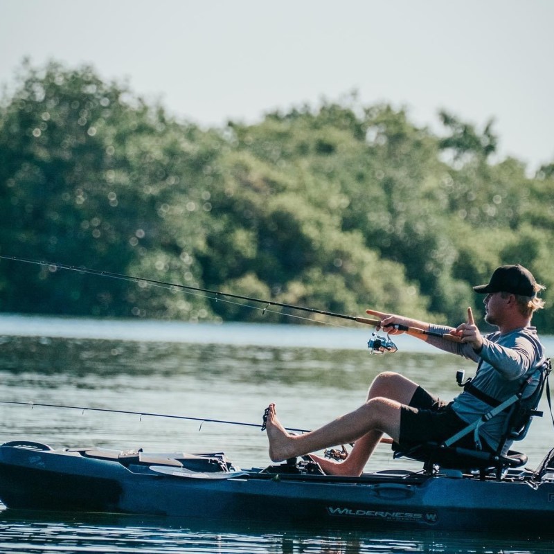 a group of people riding on the back of a boat in the water