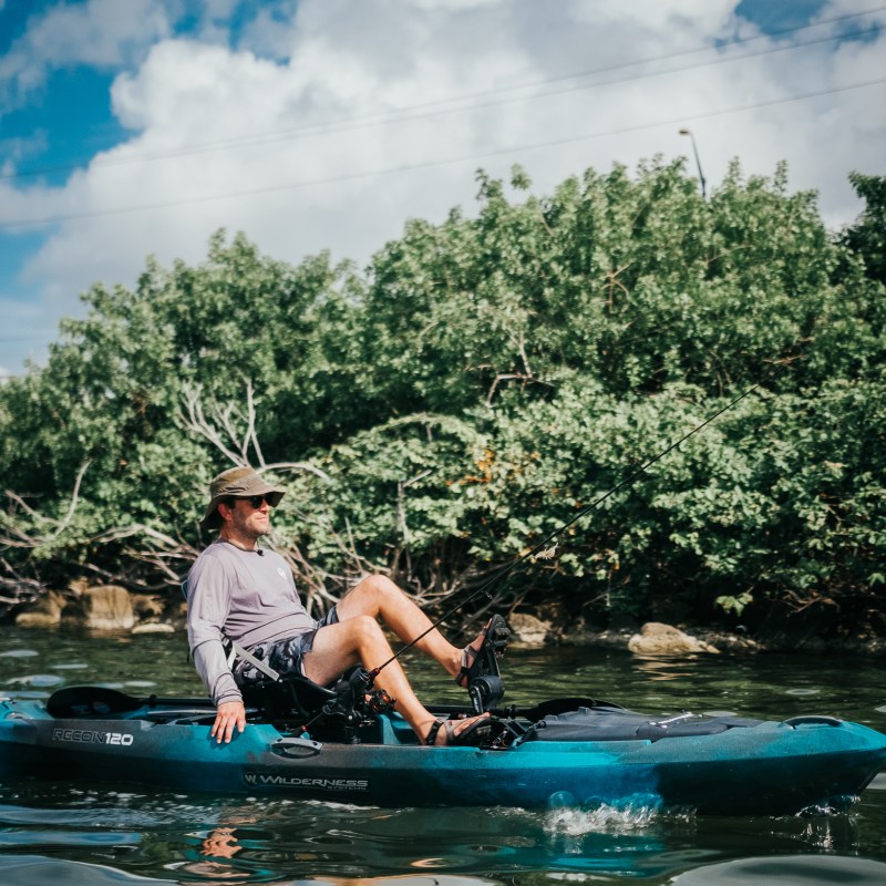 a man riding on the back of a boat in the water