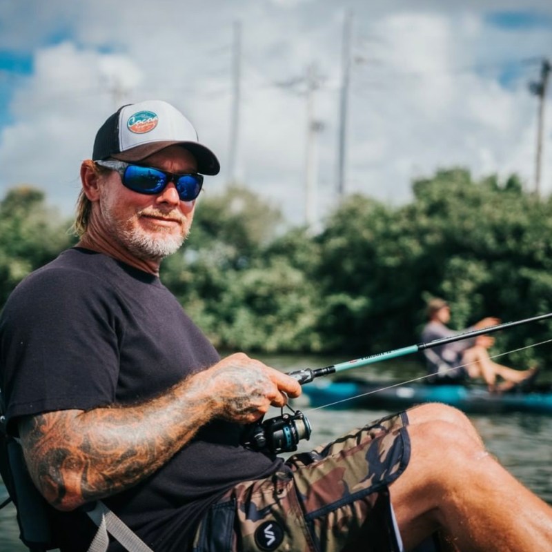 a close up of a man riding on the back of a boat