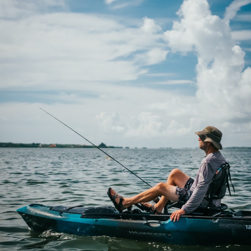 a group of people riding on the back of a boat in the water