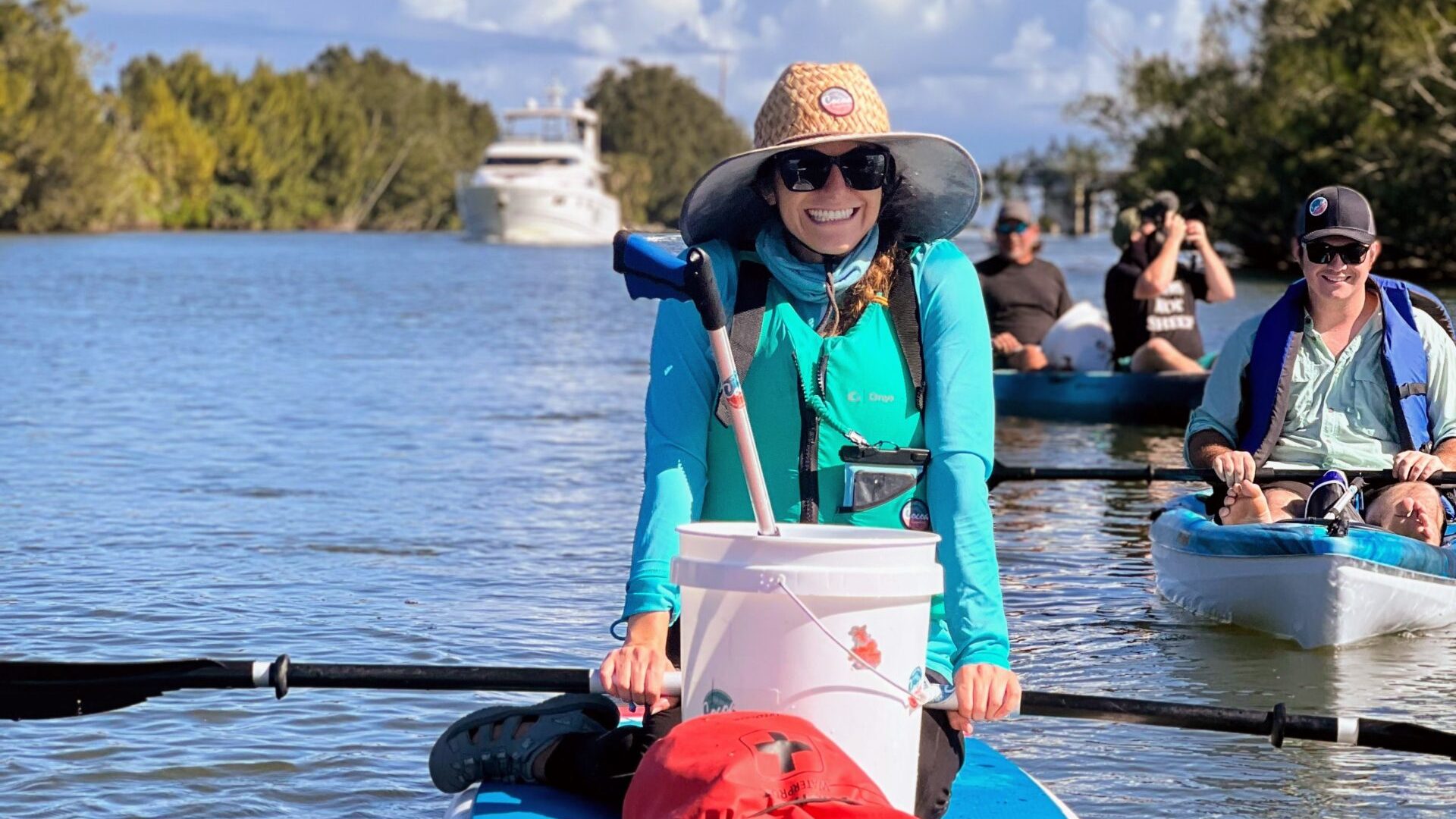 a group of people riding on the back of a boat in the water