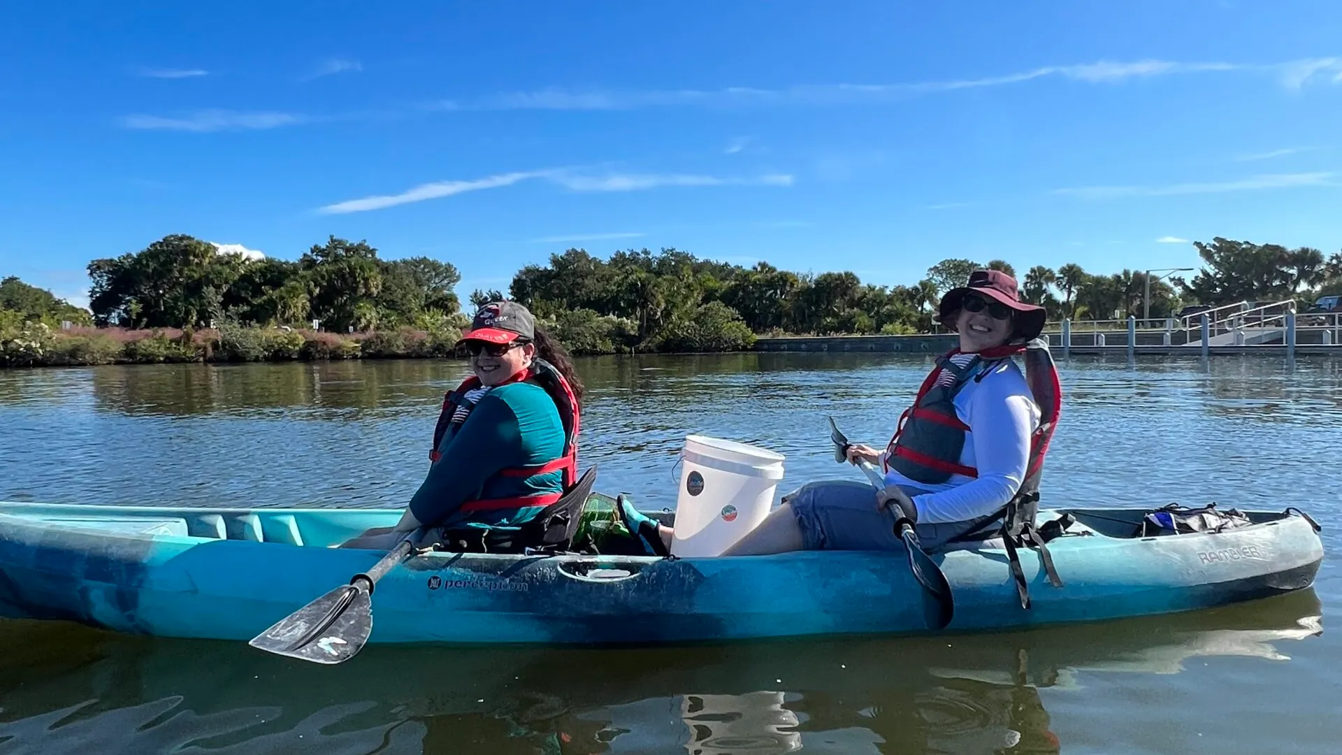 a group of people riding on the back of a boat in the water