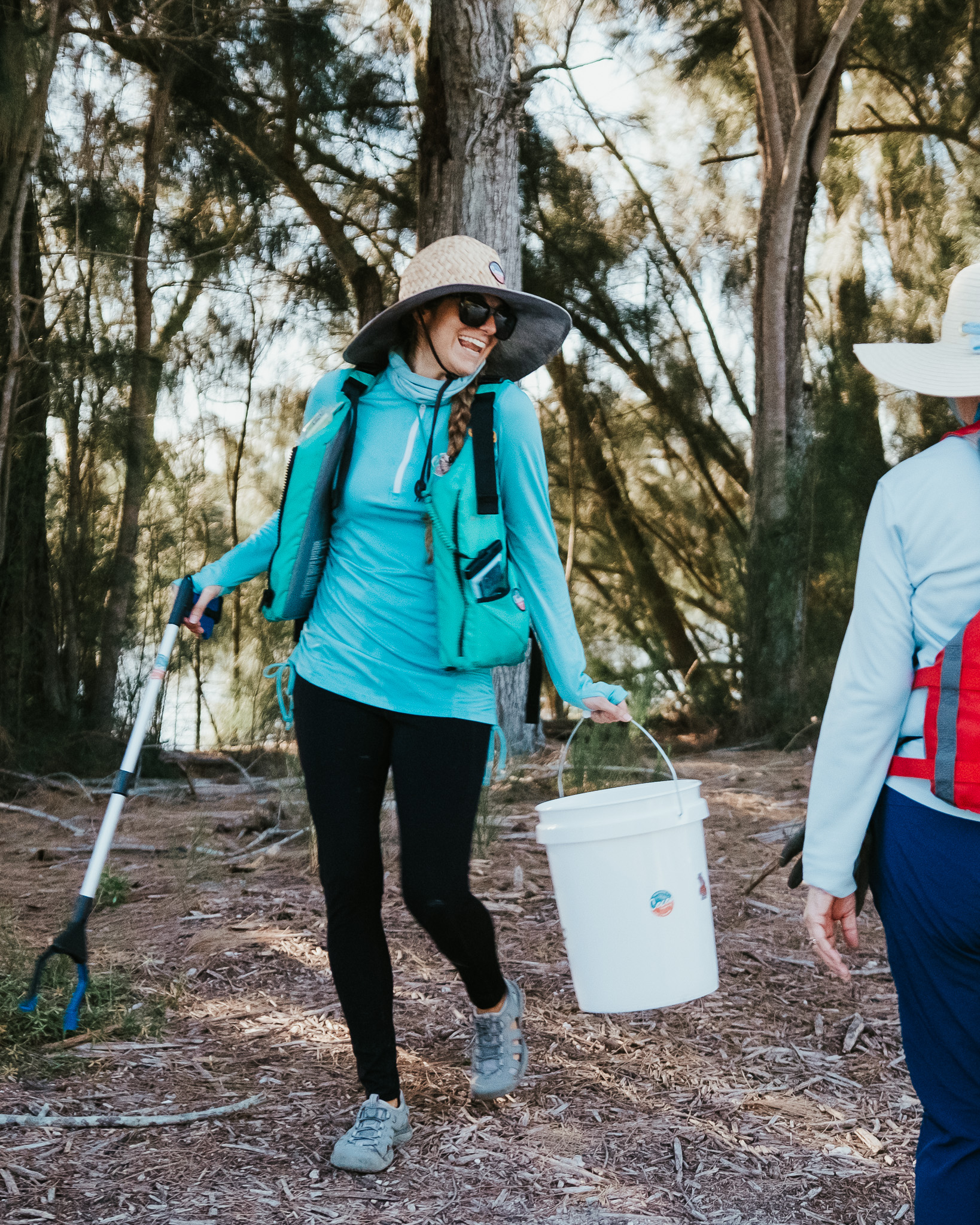 a woman standing next to a forest