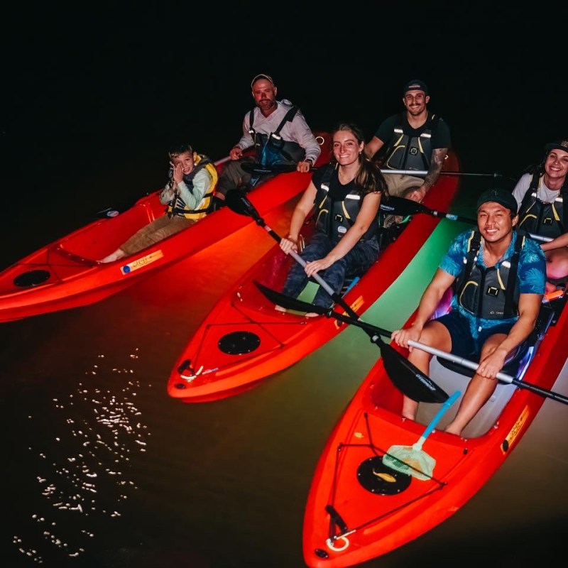 a group of men riding on the back of a boat
