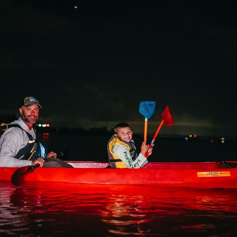 a man riding on the back of a boat in the water