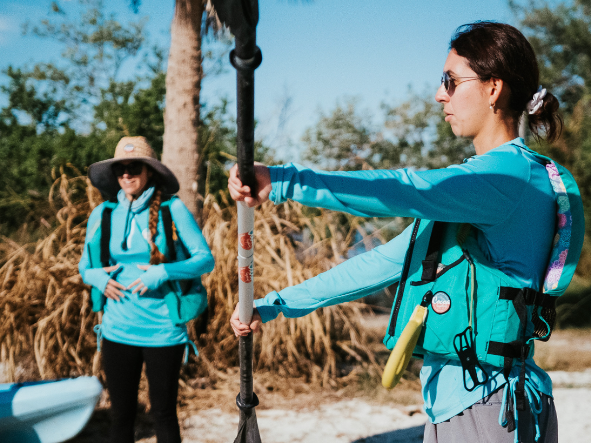 a group of people standing next to a palm tree