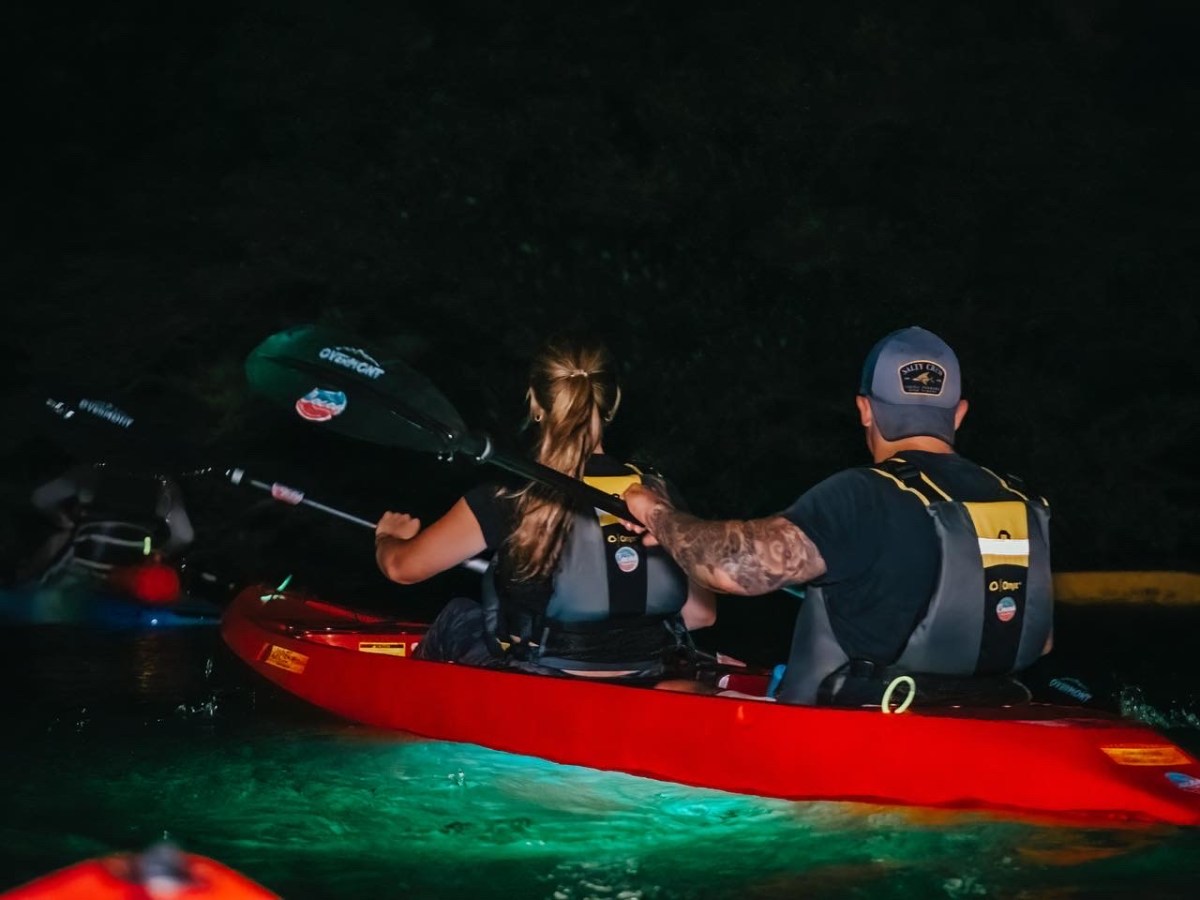 a person riding on the back of a boat