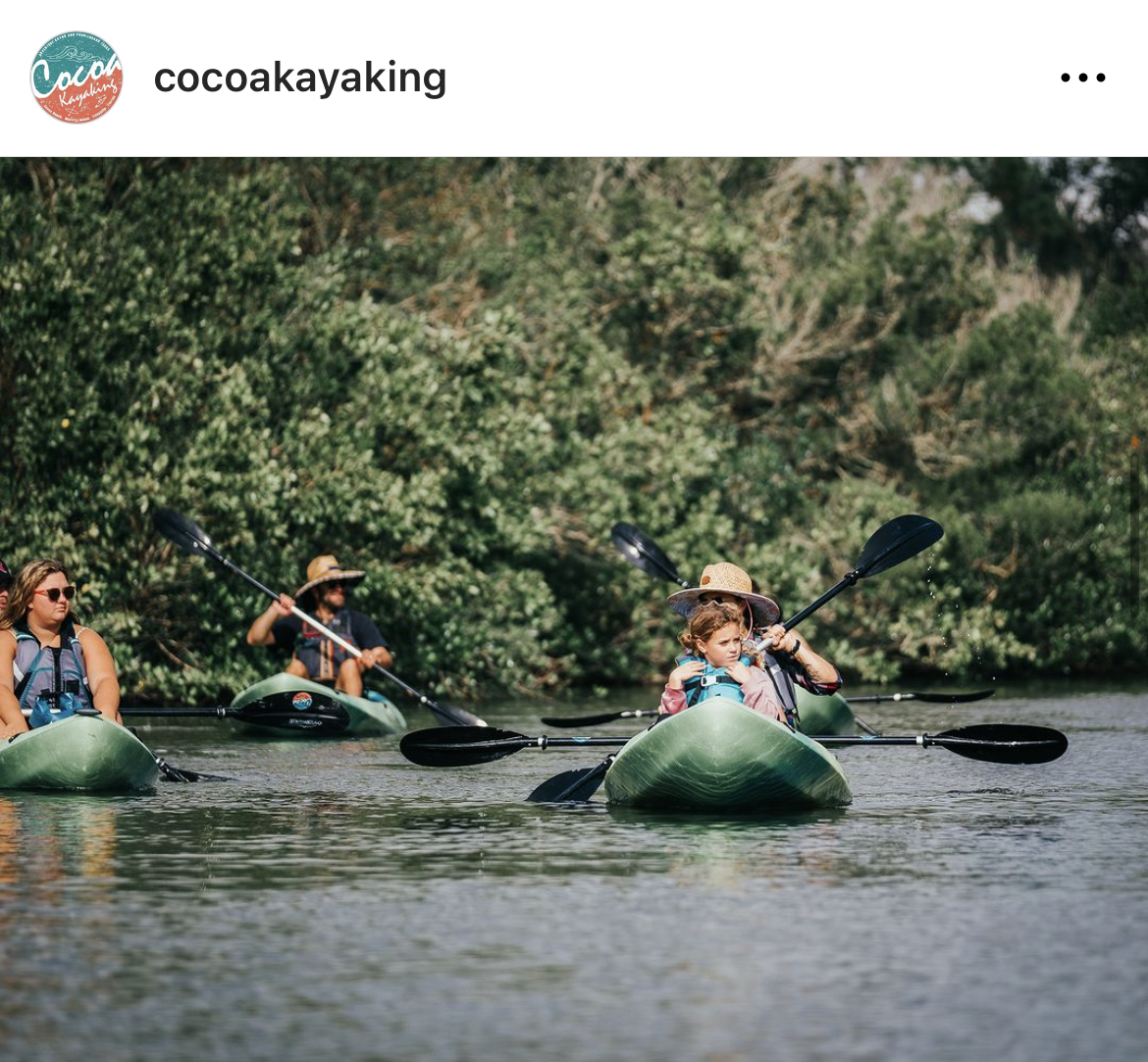 a group of people riding on the back of a boat in the water