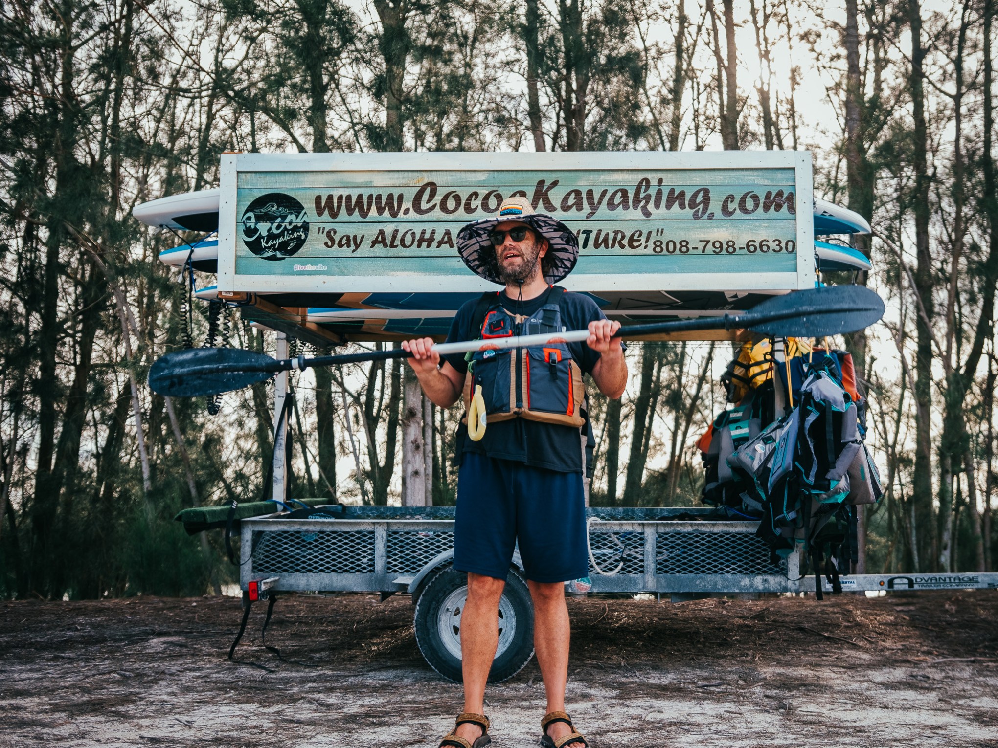 a person holding a sign posing for the camera