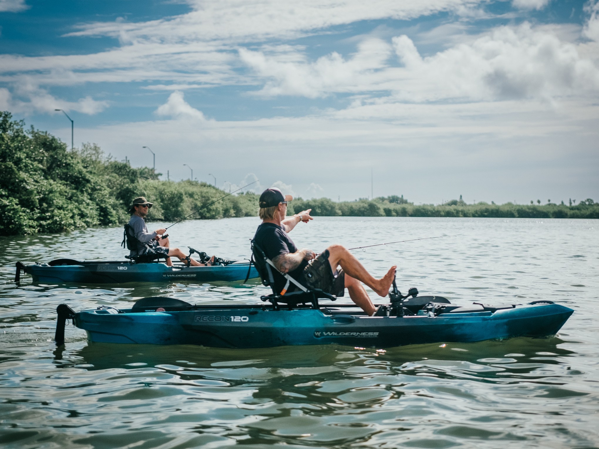 a group of people riding on the back of a boat in the water
