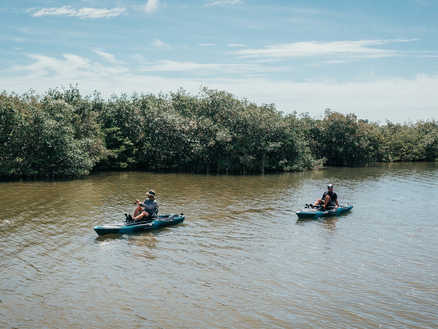 a group of people rowing a boat in a body of water