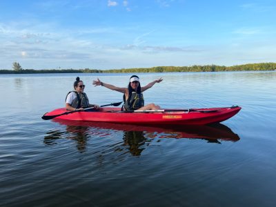 a group of people in a small boat in a body of water