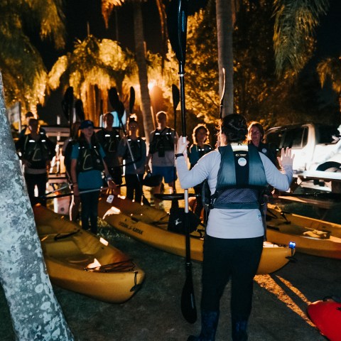 a group of people standing next to a fireplace