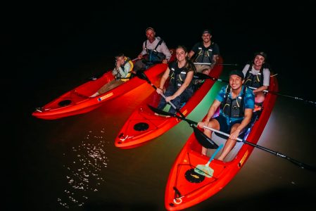 a group of people riding on the back of a boat