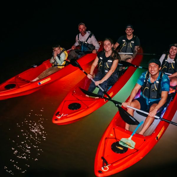 a group of people riding on the back of a boat