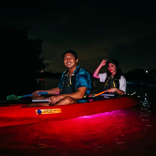 a man riding on the back of a boat in the water