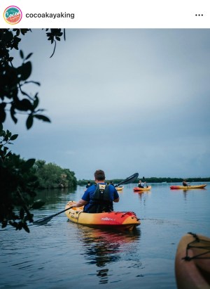 a man riding on the back of a boat in the water