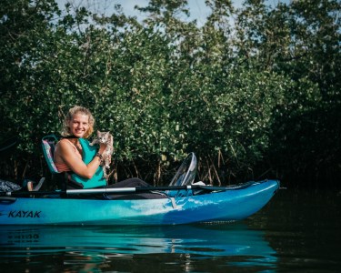 a person riding on the back of a boat in the water
