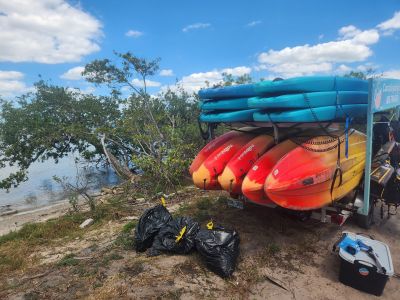 a pile of luggage sitting on top of a dirt field