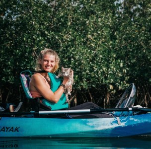 a woman sitting on a boat in the water