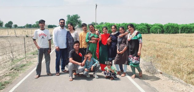 a group of people standing on the side of a road