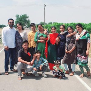 a group of people standing on the side of a road