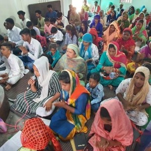 a group of people sitting and standing in front of a crowd