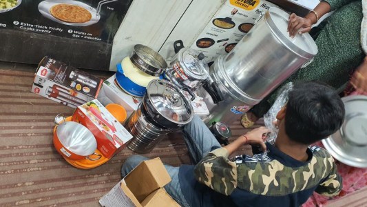 a group of people sitting at a table preparing food