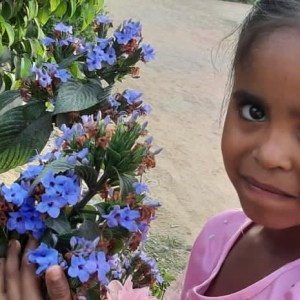 a little girl holding a flower