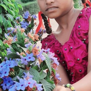 a close up of a girl holding a flower