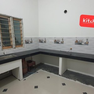 a kitchen with a sink and a mirror