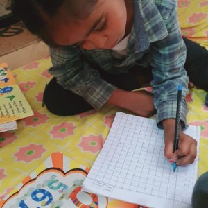 a little boy sitting on a table
