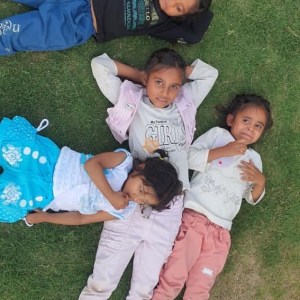 a little girl holding a baby