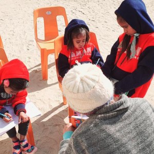 a little boy that is sitting in the snow