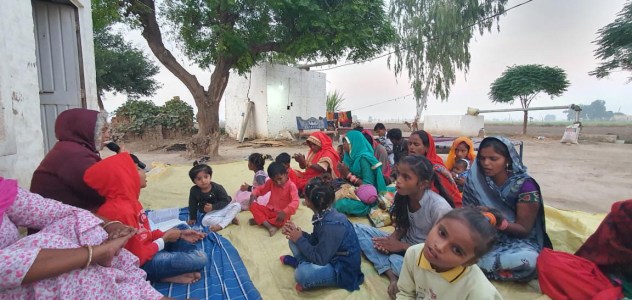 a group of people sitting on a blanket